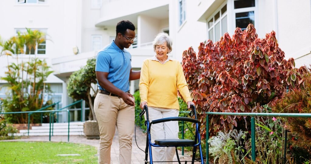 Nurse, outdoor and support with old woman and walker for rehabilitation, healthcare or helping. Med